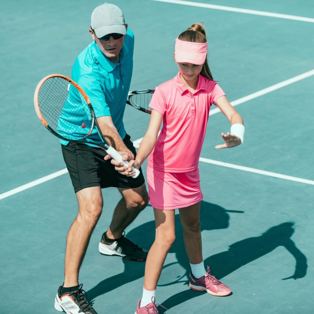 tennis coach training a kid